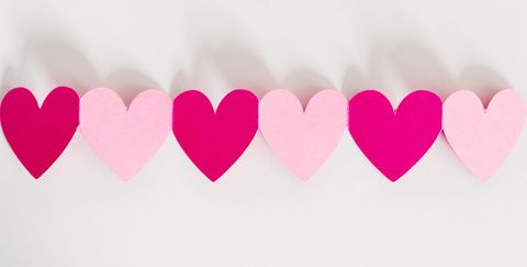 Paper cutouts of attached pink and red hearts